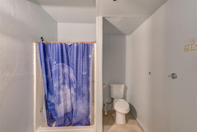 bathroom featuring tile patterned floors, toilet, and walk in shower