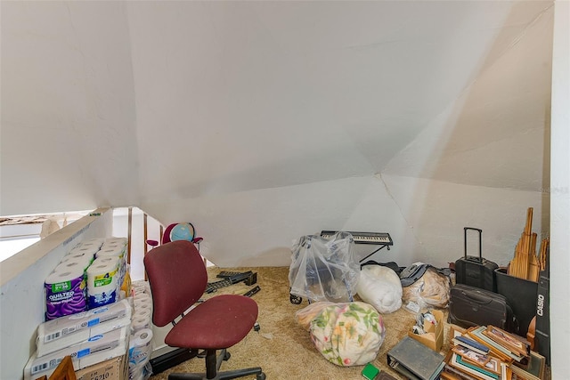 carpeted office space featuring lofted ceiling