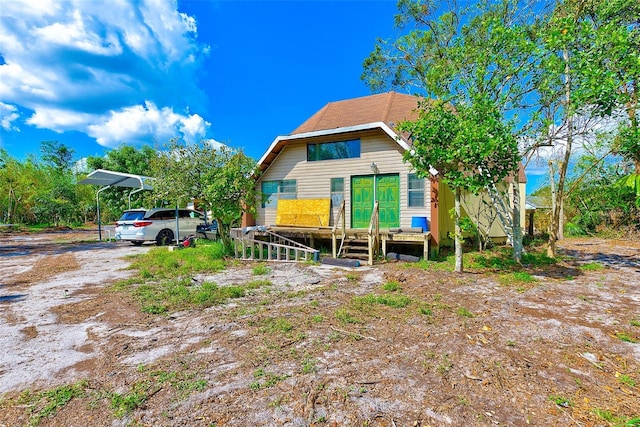 rear view of house with a carport