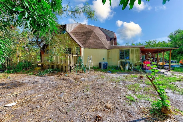 7923 18th Ave E, Palmetto, FL 34221 - rear view of property with cooling unit, a wooden deck, and roof with shingles