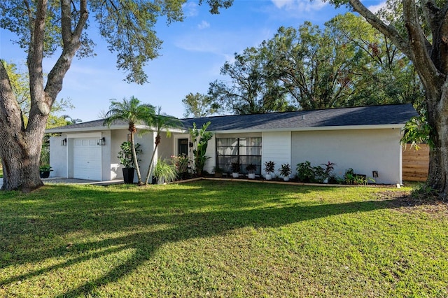 ranch-style house featuring a garage and a front lawn