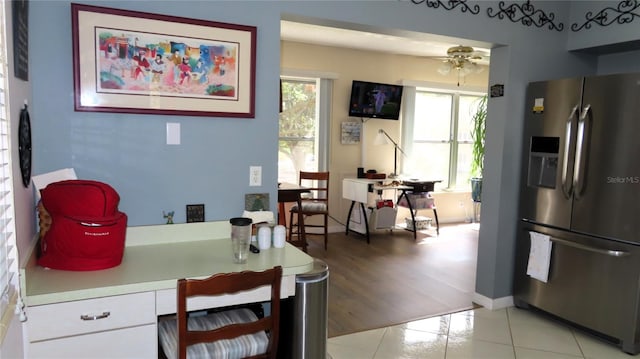 kitchen featuring white cabinetry, stainless steel fridge with ice dispenser, ceiling fan, and light hardwood / wood-style floors