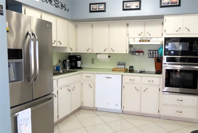 kitchen featuring white cabinetry, sink, appliances with stainless steel finishes, and light tile patterned floors