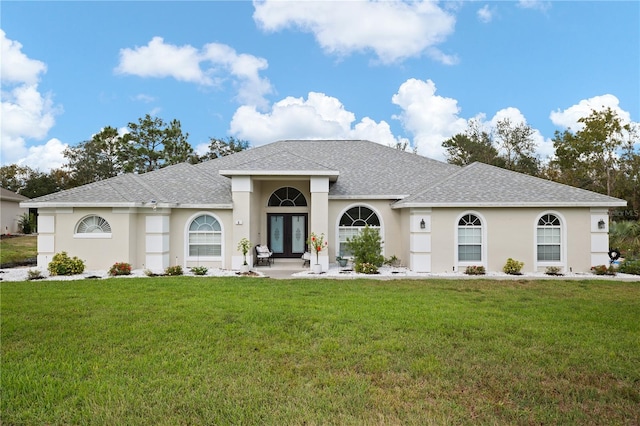 ranch-style house featuring a front yard and french doors