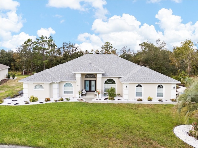 view of front of property featuring a front yard and french doors