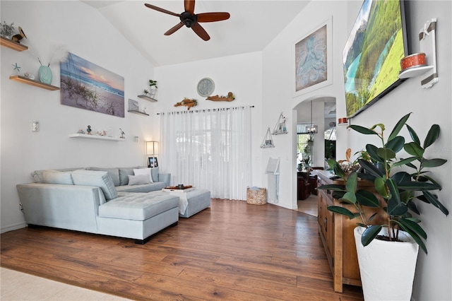 living room with ceiling fan, dark wood-type flooring, and high vaulted ceiling