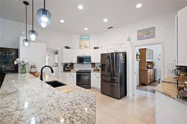 kitchen featuring black range oven, white cabinetry, sink, refrigerator with ice dispenser, and hanging light fixtures