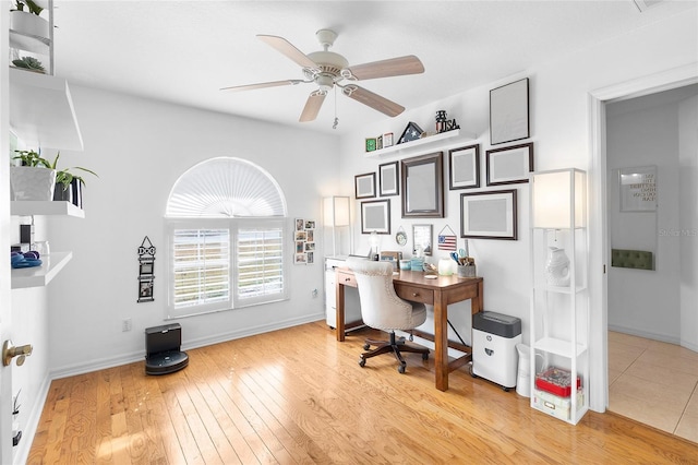 office with light hardwood / wood-style flooring and ceiling fan