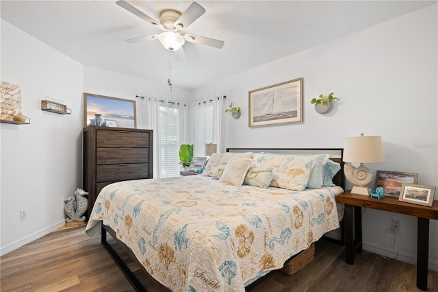 bedroom with hardwood / wood-style floors, a textured ceiling, and ceiling fan