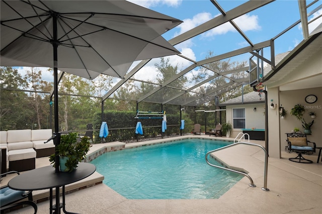 view of swimming pool with a lanai, outdoor lounge area, and a patio area