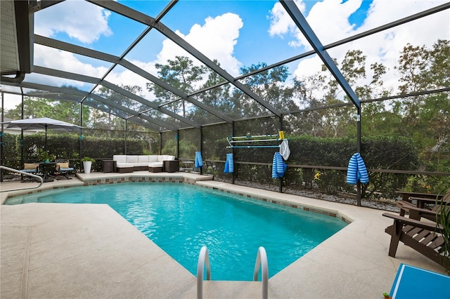 view of swimming pool featuring an outdoor living space, a lanai, and a patio area