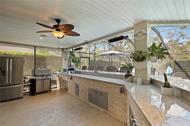 sunroom / solarium featuring wood ceiling and ceiling fan