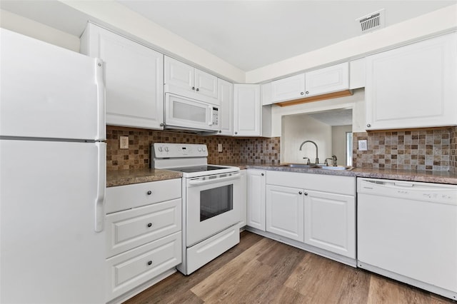 4220 Sheldon Pl Unit 4220, New Port Richey, FL 34652 - kitchen featuring white appliances, a sink, white cabinets, backsplash, and light wood finished floors