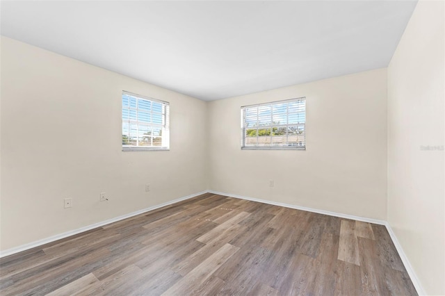 4220 Sheldon Pl Unit 4220, New Port Richey, FL 34652 - spare room featuring wood finished floors, healthy amount of natural light, and baseboards
