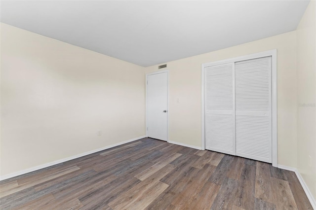 4220 Sheldon Pl Unit 4220, New Port Richey, FL 34652 - unfurnished bedroom featuring wood finished floors, baseboards, and a closet