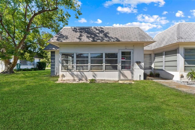 4220 Sheldon Pl Unit 4220, New Port Richey, FL 34652 - back of property with a yard, mansard roof, and roof with shingles