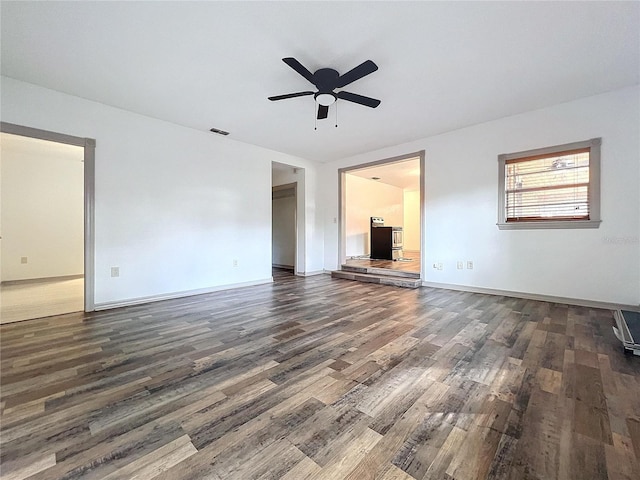 unfurnished living room with ceiling fan and dark hardwood / wood-style flooring