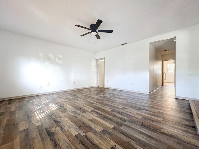 empty room featuring ceiling fan and dark wood-type flooring