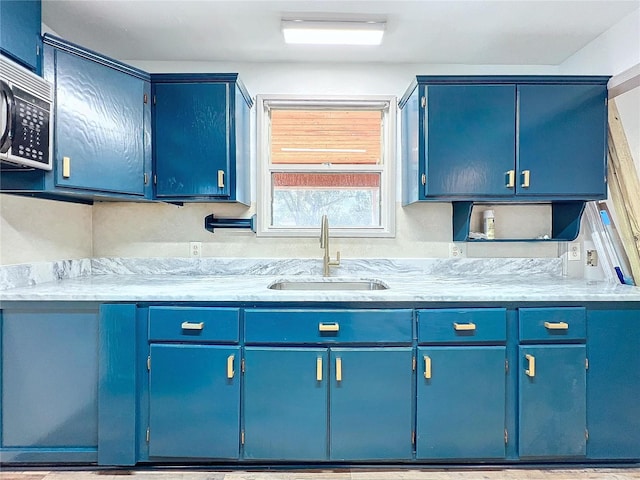 kitchen featuring blue cabinetry and sink