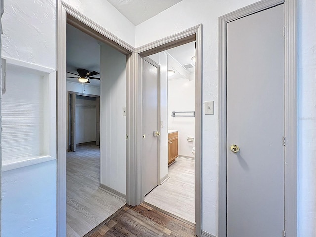 corridor featuring wood-type flooring