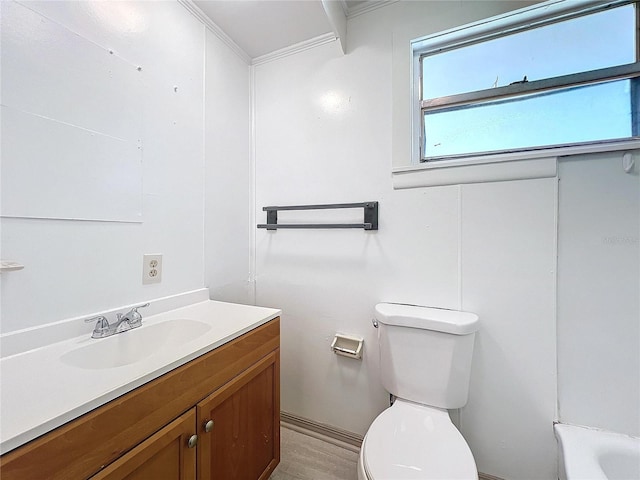 bathroom with vanity, toilet, wood-type flooring, and crown molding