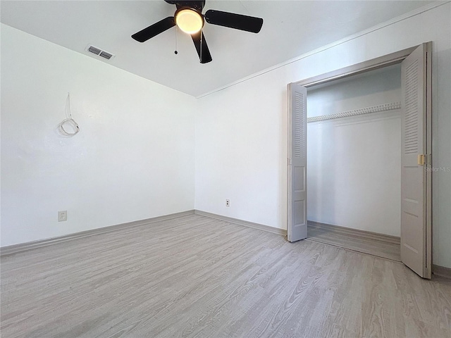 unfurnished bedroom with a closet, ceiling fan, and light hardwood / wood-style flooring