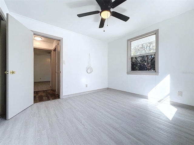 empty room featuring light wood-type flooring and ceiling fan