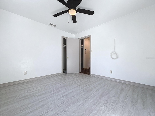 unfurnished bedroom with ceiling fan and light hardwood / wood-style floors