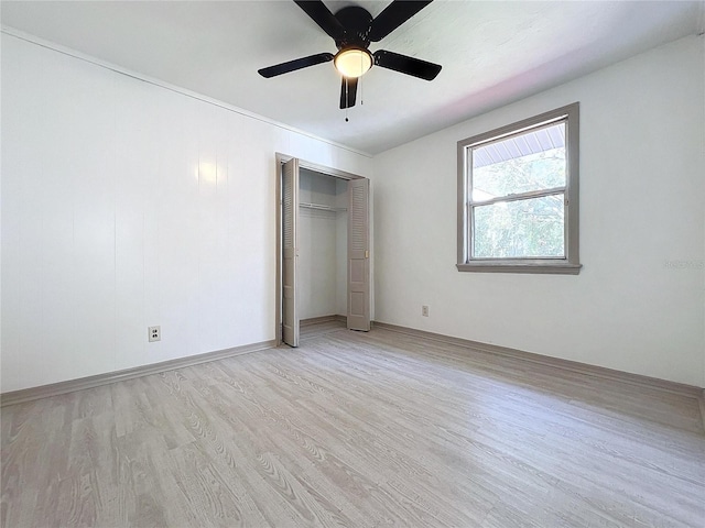 unfurnished bedroom with ceiling fan, light hardwood / wood-style floors, and a closet