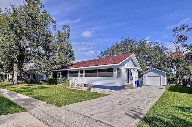 ranch-style house featuring a garage, an outdoor structure, and a front lawn