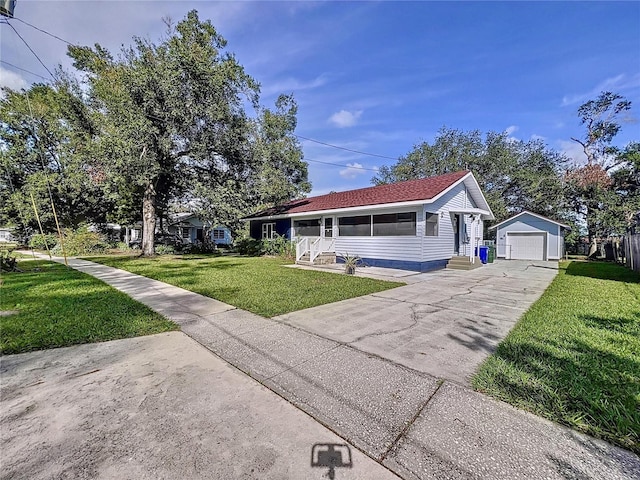 view of front of home with an outbuilding, a garage, and a front yard