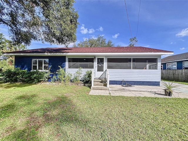 view of front of home with a patio area and a front lawn