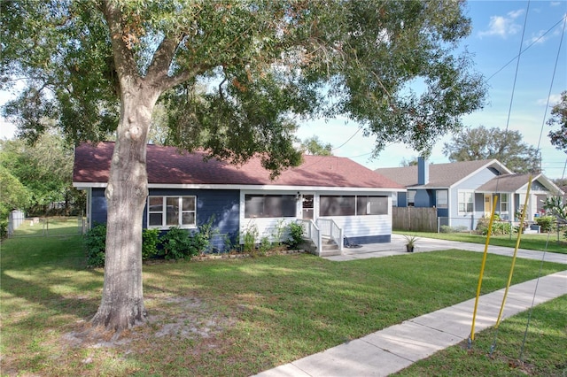 ranch-style home featuring a front lawn