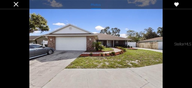 single story home with a garage and a front yard