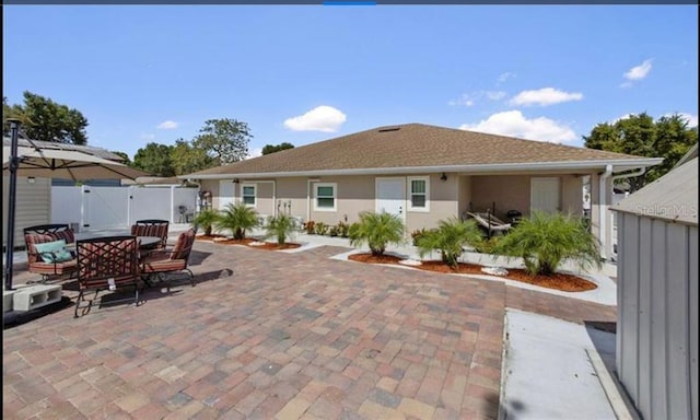 back of property with a patio