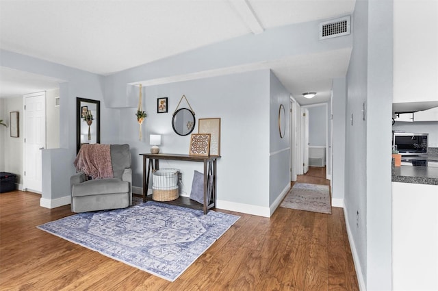 sitting room with hardwood / wood-style flooring