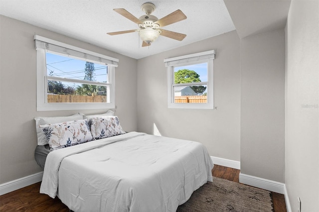 bedroom featuring ceiling fan and dark hardwood / wood-style flooring