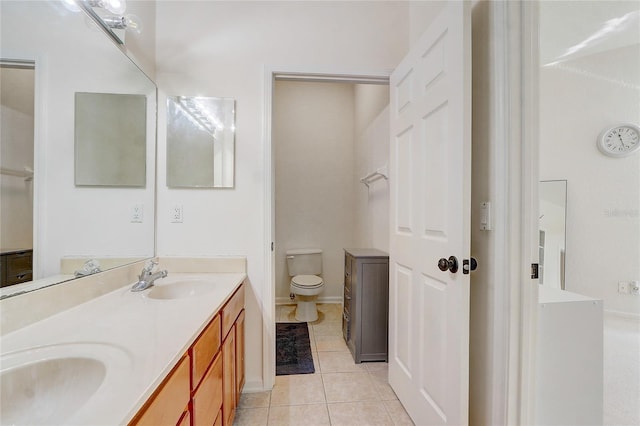 bathroom featuring tile patterned flooring, vanity, and toilet