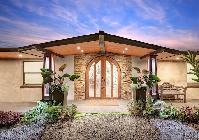 exterior entry at dusk with french doors