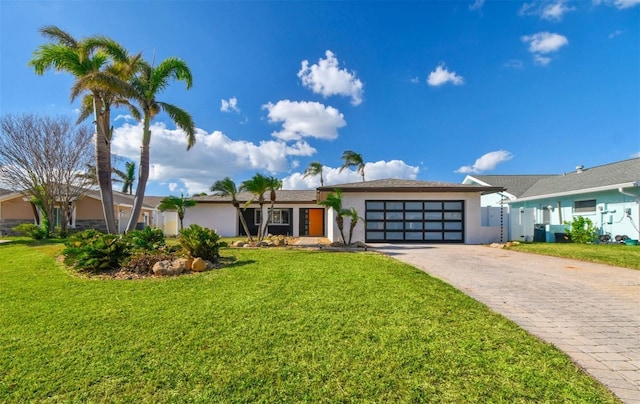 ranch-style house with a front lawn and a garage