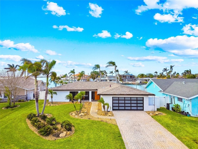 ranch-style home featuring a garage and a front yard