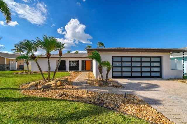 view of front facade with a front lawn and a garage