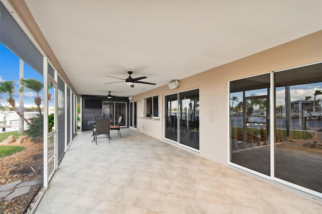 unfurnished sunroom with ceiling fan and a healthy amount of sunlight