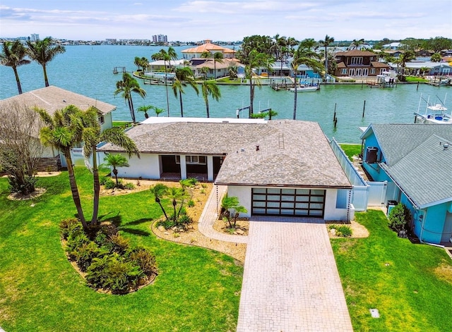 11683 Grove St, Seminole, FL 33772 - view of front of property featuring an attached garage, a water view, decorative driveway, and stucco siding