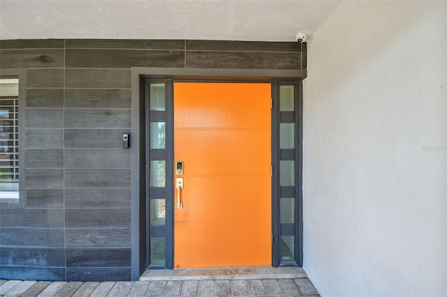 11683 Grove St, Seminole, FL 33772 - doorway to property with a security system and stucco siding