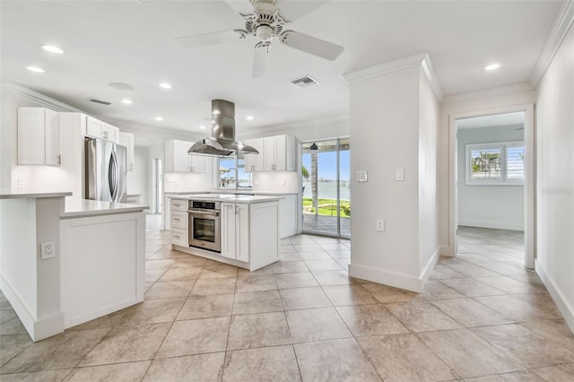 11683 Grove St, Seminole, FL 33772 - kitchen with appliances with stainless steel finishes, island exhaust hood, ornamental molding, light countertops, and recessed lighting