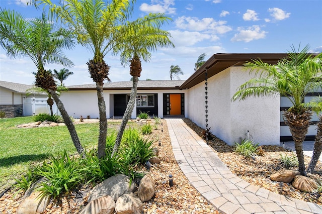 11683 Grove St, Seminole, FL 33772 - view of front of home with stucco siding and a front yard