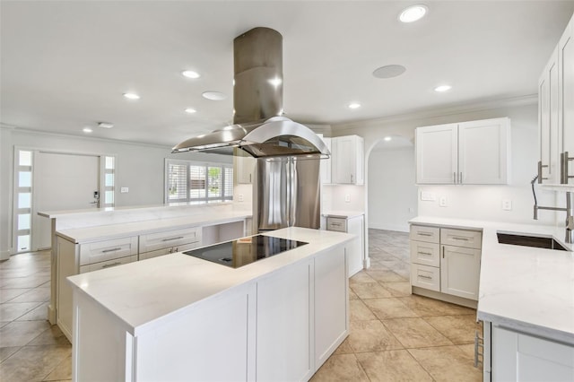 11683 Grove St, Seminole, FL 33772 - kitchen with island exhaust hood, black electric stovetop, crown molding, a center island, and a peninsula