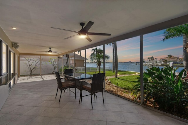 11683 Grove St, Seminole, FL 33772 - sunroom featuring a water view, a ceiling fan, outdoor dining area, and plenty of natural light