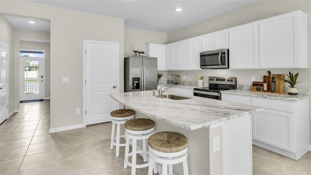 2472 Mellow Ln, Clearwater, FL 33765 - kitchen featuring stainless steel appliances, a sink, light tile patterned flooring, white cabinets, and recessed lighting